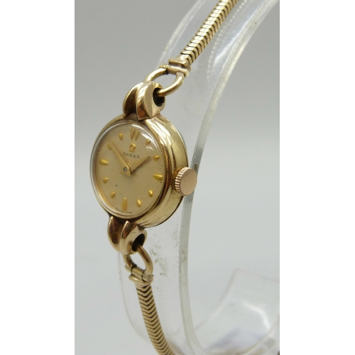 7148 - A lady's 9ct gold Omega wristwatch on a 9ct gold strap, 14.8g, 20mm including crown