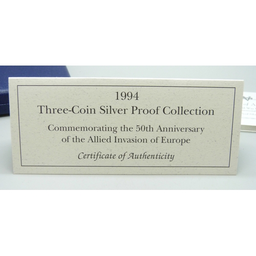 7183 - The Royal Mint, a 1994 silver proof three coin collection, silver dollar (26.73g 90%), 1 franc (22.2... 