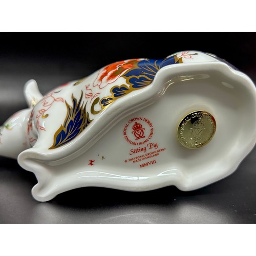 A Royal Crown Derby Sitting Pig paperweight, gold stopper, boxed