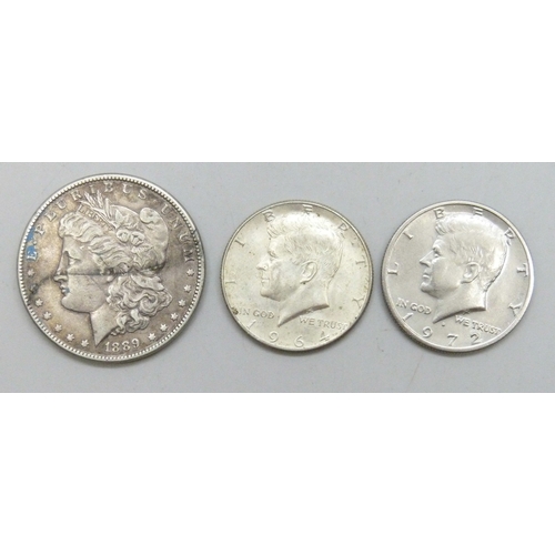 7242 - A USA one dollar coin, 1889, a USA half dollar, 1964, and another USA half dollar, 1972