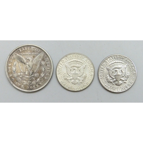 7242 - A USA one dollar coin, 1889, a USA half dollar, 1964, and another USA half dollar, 1972