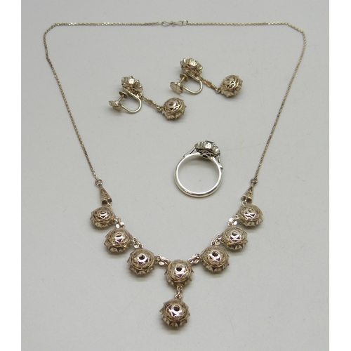7009 - A vintage white metal, garnet and white stone cluster jewellery suit - a pair of screw back drop ear... 