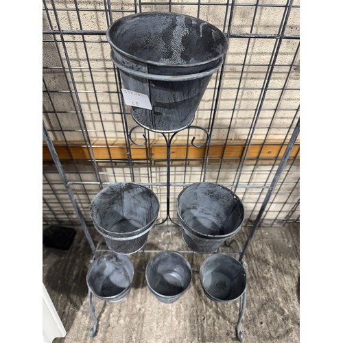 3008 - A free standing metal six pot garden planter