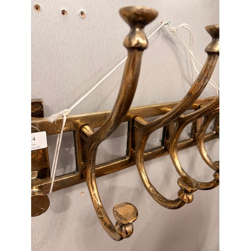 3014 - A gold effect five hook coat rack
