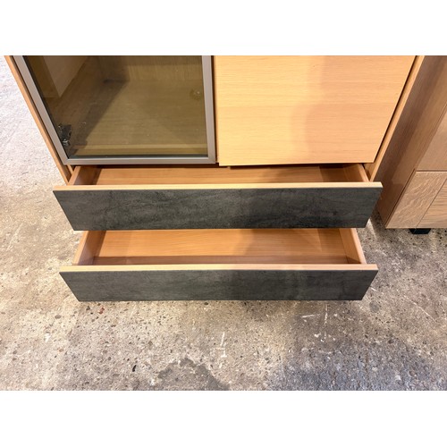 3081 - A two drawer three door wood and glass cabinet (CFL-318-50)