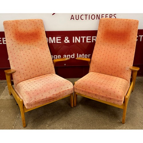 52 - A pair of Norweigan Arnestad Bruk beech and fabric upholstered Rock 'n' Rest armchairs, designed by ... 
