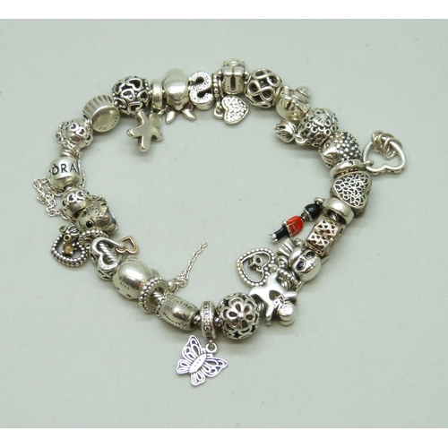 7010 - A heavy silver Pandora charm bracelet, with a collection of mainly Pandora charms, 91g total
