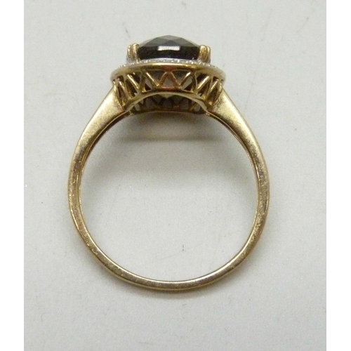 7015 - A 9ct gold, smoky quartz and diamond ring, 4.4g, W