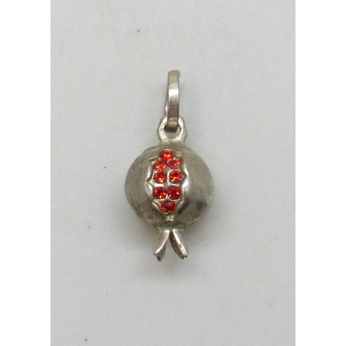 7031 - A silver necklace pendant in the form of a pomegranate set with red paste stones, 1.9cm including ba... 
