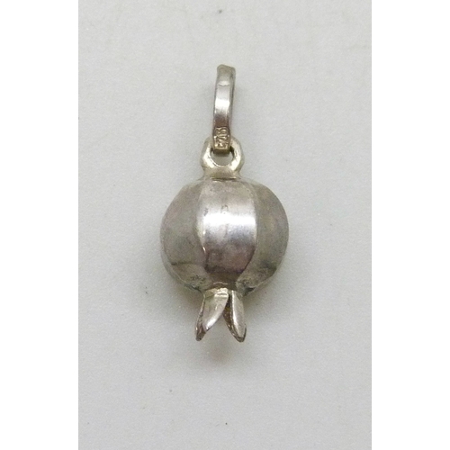 7031 - A silver necklace pendant in the form of a pomegranate set with red paste stones, 1.9cm including ba... 