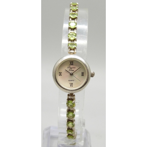 7058 - A silver and peridot lady's wristwatch, 24g, 19cm