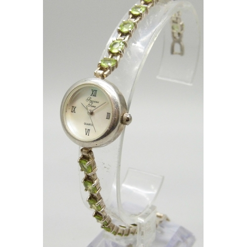 7058 - A silver and peridot lady's wristwatch, 24g, 19cm