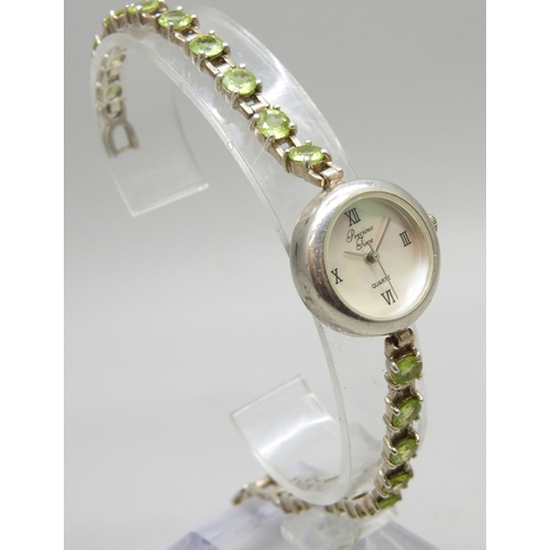 7058 - A silver and peridot lady's wristwatch, 24g, 19cm