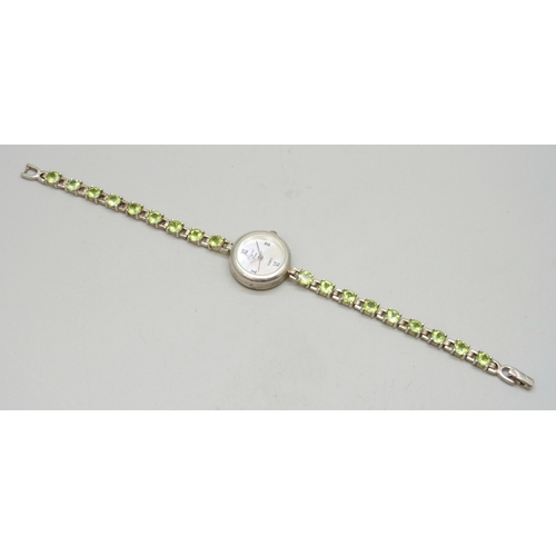 7058 - A silver and peridot lady's wristwatch, 24g, 19cm