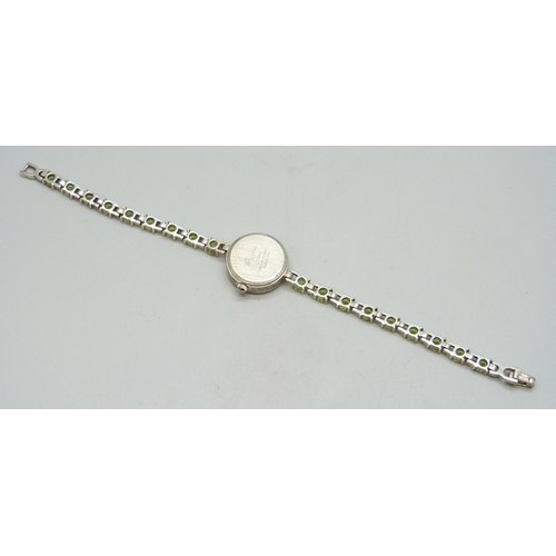 7058 - A silver and peridot lady's wristwatch, 24g, 19cm