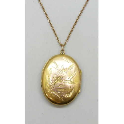7059 - A 9ct gold locket with engraved design, Birmingham, 1918, 3.5cm including loop, and a 9ct gold chain... 