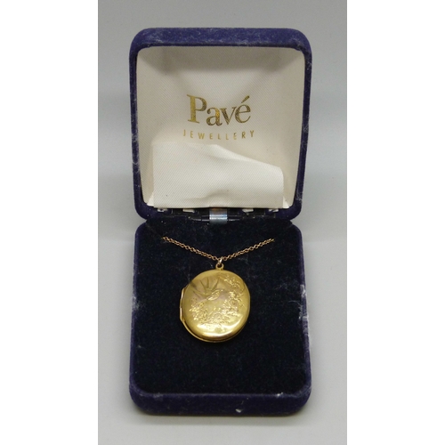 7059 - A 9ct gold locket with engraved design, Birmingham, 1918, 3.5cm including loop, and a 9ct gold chain... 