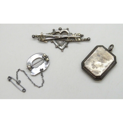 7061 - A Victorian silver bar brooch, 5cm, an early 20th century silver locket, both hallmarked, and a whit... 