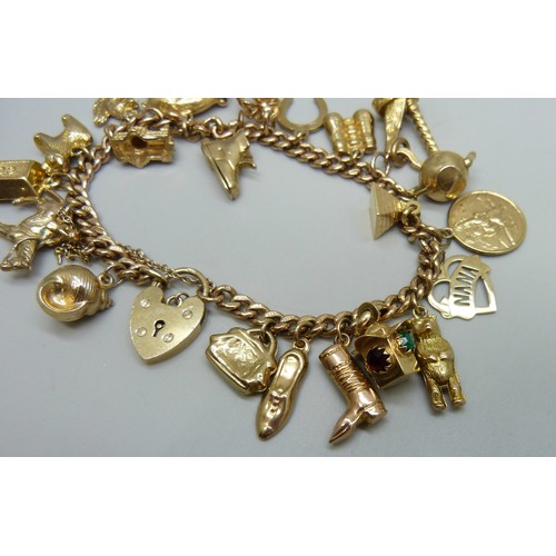 7237D - A 9ct gold curb chain bracelet with padlock clasp, with a collection of 9ct gold charms, a 15ct gold... 