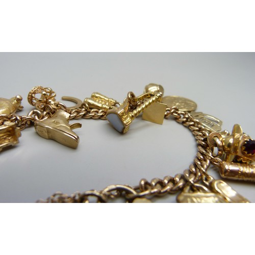 7237D - A 9ct gold curb chain bracelet with padlock clasp, with a collection of 9ct gold charms, a 15ct gold... 