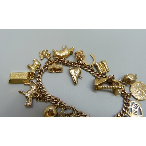 7237D - A 9ct gold curb chain bracelet with padlock clasp, with a collection of 9ct gold charms, a 15ct gold... 