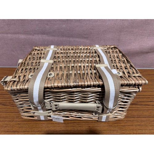 3066 - A wicker picnic basket and cutlery