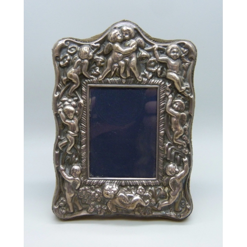 7001 - A Carr's Victorian style silver photograph frame with embossed cherubs, Sheffield, 1987, 12.5 x 9cm,... 