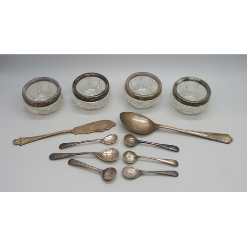 7023 - Four silver rimmed cut glass salts, six silver condiment spoons and other silver, weighable silver 6... 
