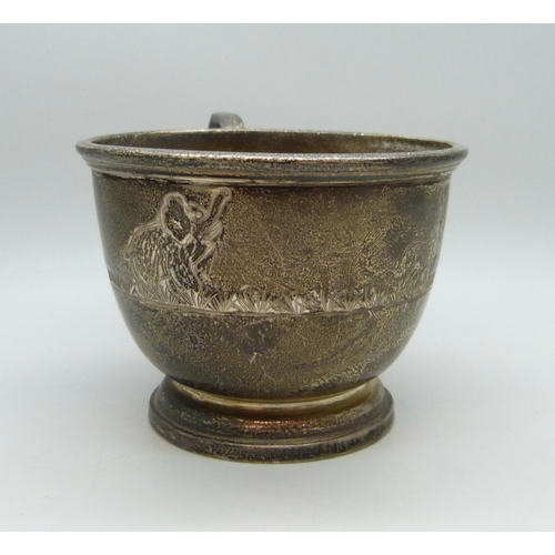 7028 - A silver christening mug with animal design, slightly misshapen, Birmingham, 1977, 94g, 6.2cm to top... 