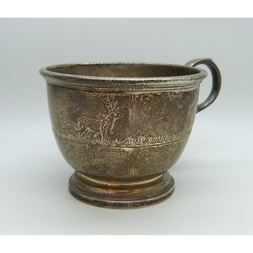 7028 - A silver christening mug with animal design, slightly misshapen, Birmingham, 1977, 94g, 6.2cm to top... 