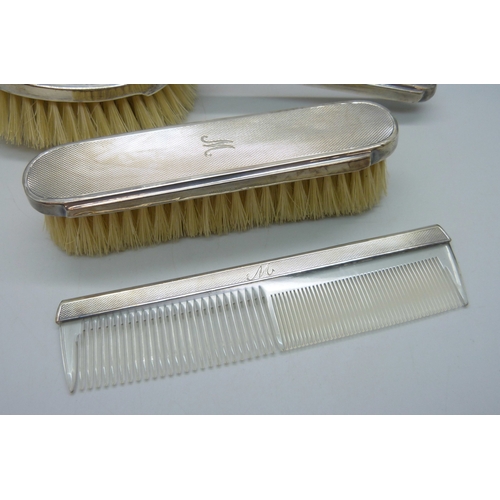 7035 - Two Mappin & Webb silver backed brushes, and an unmatched silver mounted comb, all with monograms, 2... 
