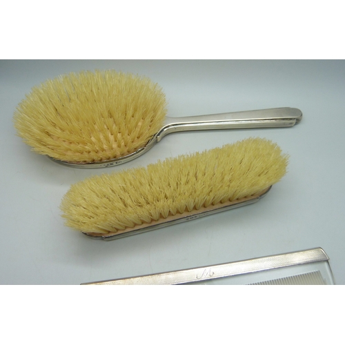 7035 - Two Mappin & Webb silver backed brushes, and an unmatched silver mounted comb, all with monograms, 2... 