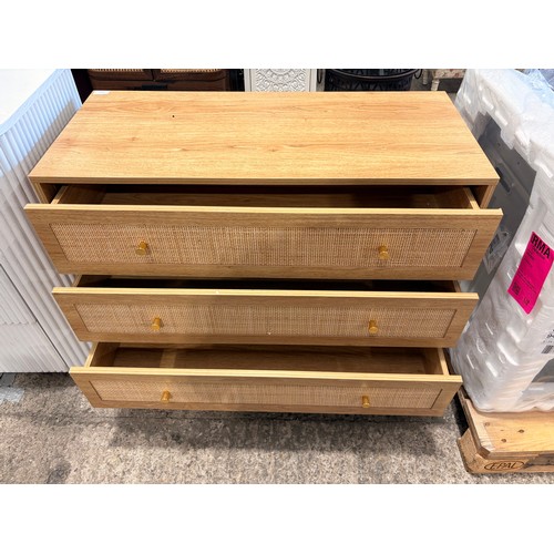 3126 - An oak and rattan 3 drawer chest with brass effect handles