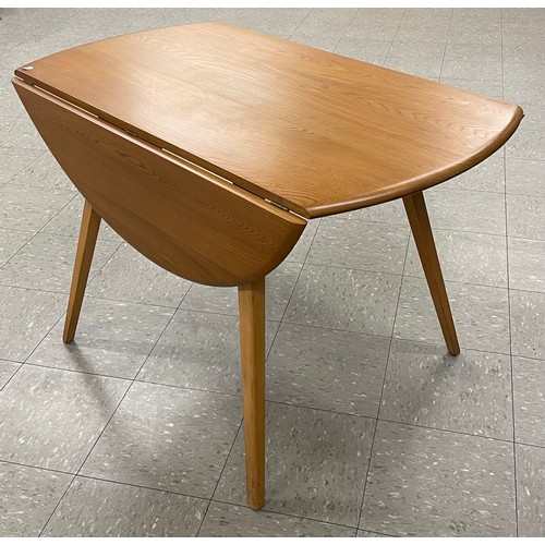 53 - An Ercol Blonde elm and beech Windsor drop-leaf table and four Goldmsith chairs