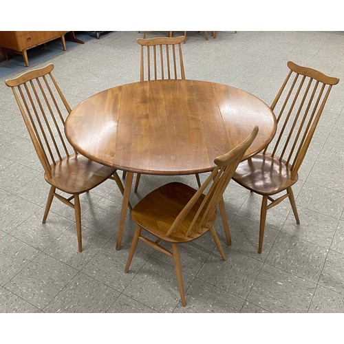 54 - An Ercol Blonde elm and beech Windsor drop-leaf table and four Goldsmith chairs