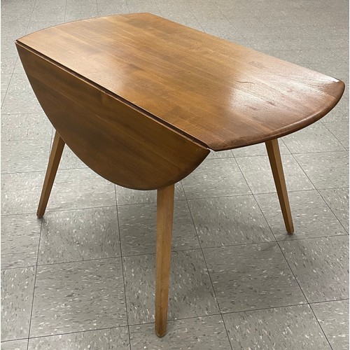 54 - An Ercol Blonde elm and beech Windsor drop-leaf table and four Goldsmith chairs