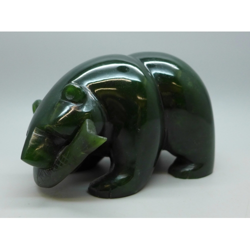 2030 - A carved green nephrite bear figure with fish, 6cm h