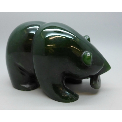 2030 - A carved green nephrite bear figure with fish, 6cm h