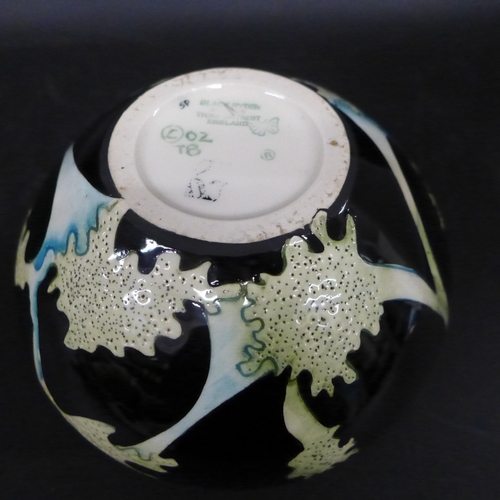 2031 - A Black Ryden Pottery vase in Papaver pattern, designed by Kerry Goodwin, of squat form, approx. 9cm... 