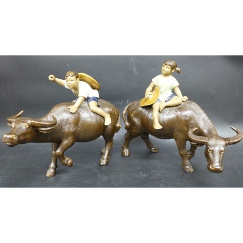 2049 - A pair of Shiwan ceramic figures, buffalos with riders, repairs to legs, 15.5cm h