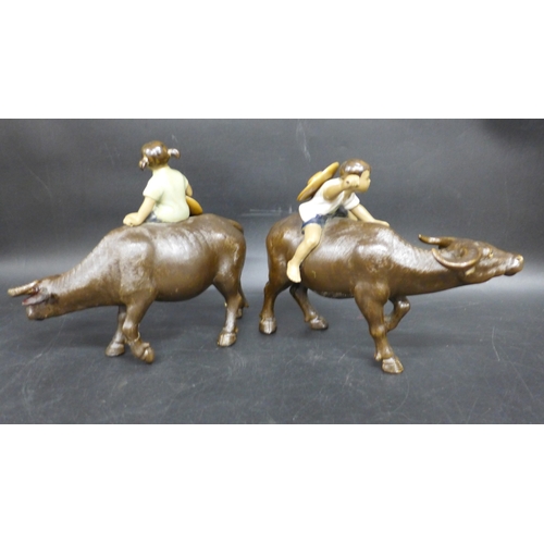 2049 - A pair of Shiwan ceramic figures, buffalos with riders, repairs to legs, 15.5cm h