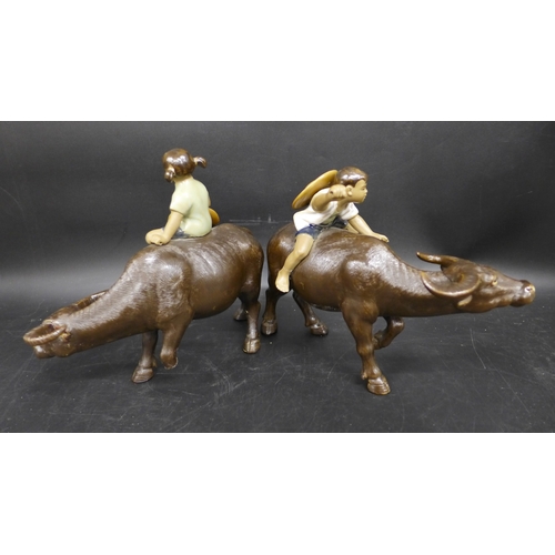 2049 - A pair of Shiwan ceramic figures, buffalos with riders, repairs to legs, 15.5cm h