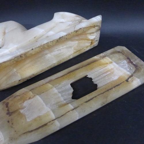 2057 - An alabaster carved Egyptian Sphinx, 19cm long, and base
