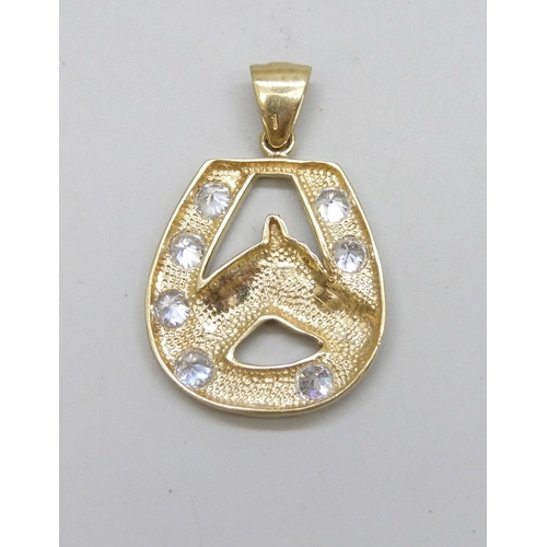 7051 - A 9ct gold horseshoe design necklace pendant set with white stones, 16.4g, 5cm including bail