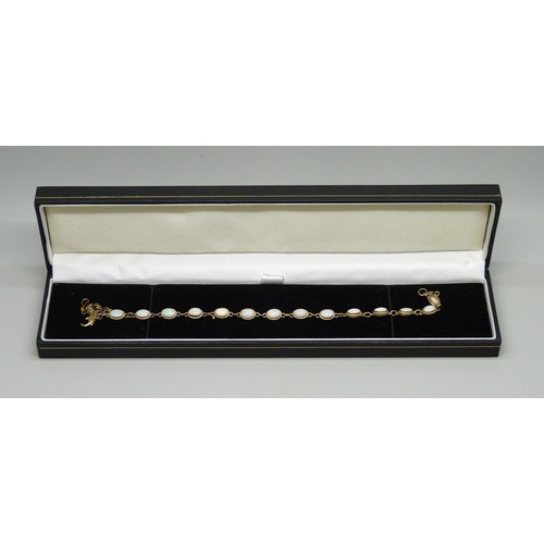 7056 - A 9ct gold and opal line bracelet, clasp a/f, 5.2g, 19.7cm