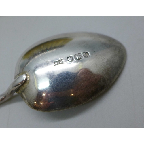 7037 - A Victorian silver backed brush, London, 1889, and a silver golf design spoon, 47g total