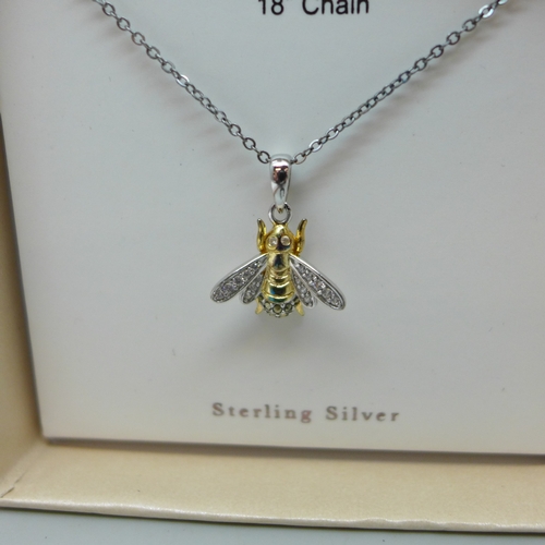 7038 - A silver pendant on chain in the form of a bee, a silver and white stone necklace and earrings, a si... 