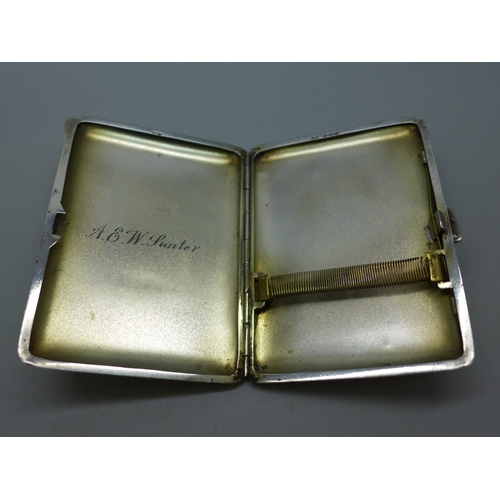 7042 - A silver cigarette case with green guilloche enamel decoration, silver import marks and personalised... 