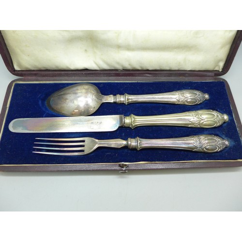 7049 - A three piece cutlery set, boxed