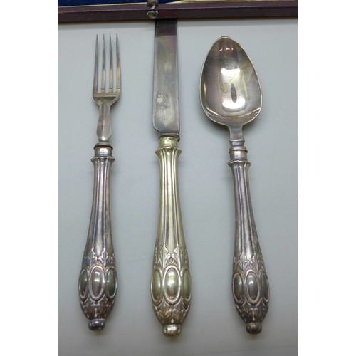 7049 - A three piece cutlery set, boxed
